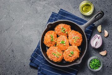Cabbage rissoles in cast iron skillet. Top view, space for text.