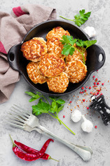 Cutlets. Fried cutlets in cast-iron pan on table