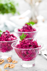 Beet salad. Salad of boiled beet. Beetroot salad with prune, walnuts and sour cream on white background