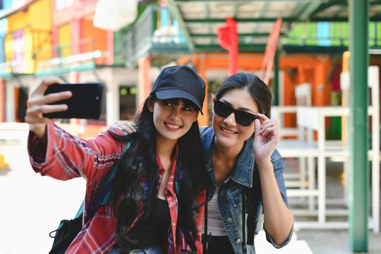 Travel and relaxing Concepts, Tourists are taking photos in the city. Asian girls are happily traveling. Beautiful girl is relaxing Travel
