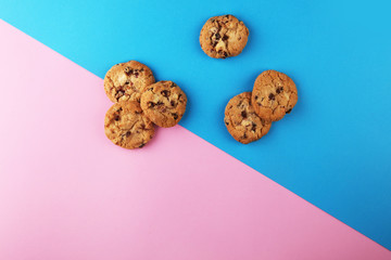 Chocolate cookies flat lay on colored paper.