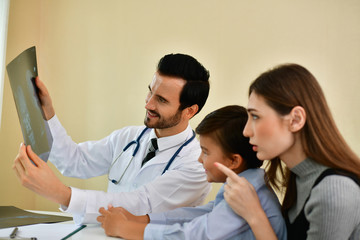 Health Concepts. Doctor and patient viewing x-ray film. The doctor and the patient feel relaxed at the check-in time. The doctor encouraged the patient. Inside the hospital are doctor X-ray patient.