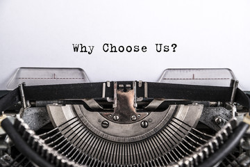 Why Choose Us? the text is typed on an old vintage typewriter with white paper. Business idea