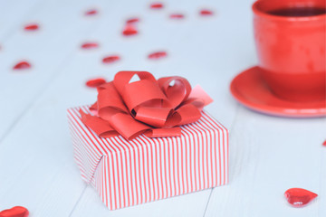 close-up background image of red Cup and gift box on light background.