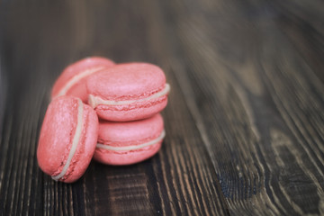 Colorful macaroons and flowers on table
