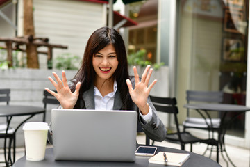 Business Concept.Young Asian businesswoman is working happily.Young businesswoman working in a cafe.Young businesswoman is relaxation in a coffee shop.