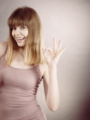 Portrait of happy blonde woman smiling with joy