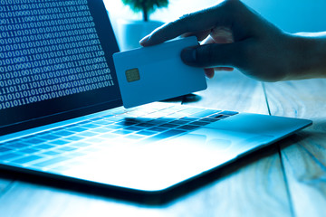 The concept of credit card theft. Hackers with credit cards on laptops use these data for...