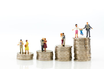 Miniature people: Group couple figure sitting on top of stack coins. Image use for retirement planning, Life insurance concept.
