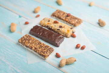 Tasty granola bars on wooden table