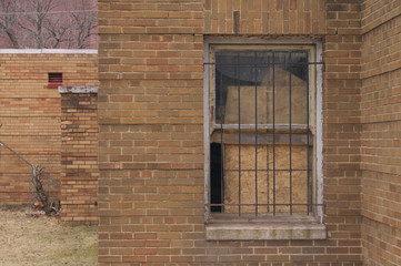 Brick Building Broken Windows with Bars