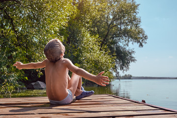 Young boy swimming and sunbathing during summer holidays