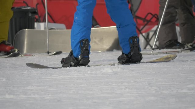 Legs standing on the snowboard