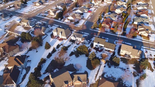 Beautiful neighborhoods still in the grip of Winter but turning toward Spring, aerial view.