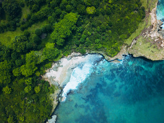 Top view or Aerial view of tropical island forest and emerald clear water of south coast in west sumatera, indonesia.