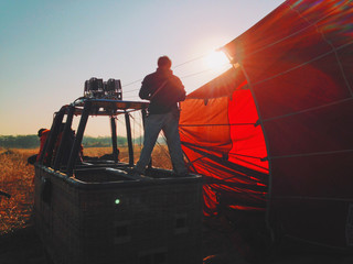 Filling with hot air of red balloons	
