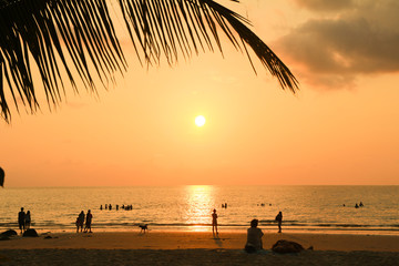 silhouette peoples sunset at the sea beach orange sky beautiful clouds 