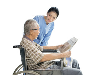 Young female nurse smiling at elderly man