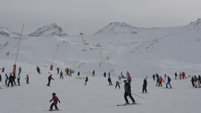 People skiing on a ski slope in the mountains 