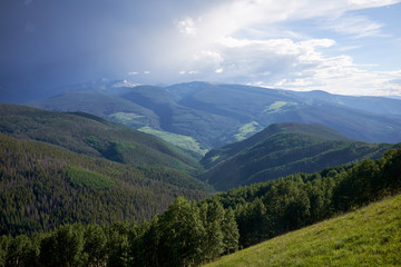Fototapeta na wymiar Scenic green forested valley and cloudscape