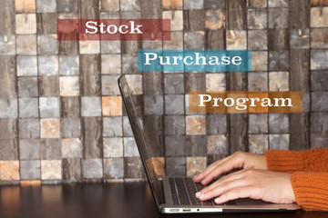 business hand women using a laptop and stock purchase program concept