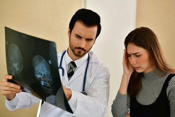 Health Concepts. Doctor and patient viewing x-ray film. The doctor and the patient feel relaxed at the check-in time. The doctor encouraged the patient. Inside the hospital are doctor X-ray patient.