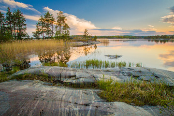 Nature of Russia. The Republic of Karelia. Reflection of clouds in the water. Islands on the horizon. Wild nature. Calm on the lake. Karelia Ladoga Lake.