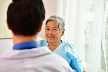 Fototapeta premium Concept of healing care, The doctor is healing old woman.