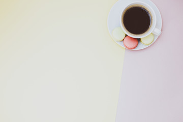 Flat lay of coffee cup with macaroons