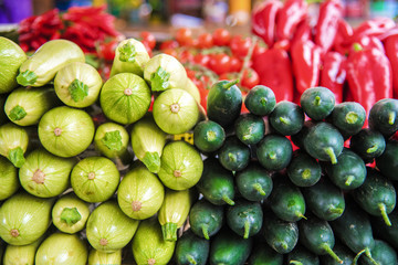 Vegetables at the food market - cucumbers and zucchini