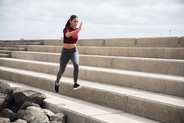 Young pretty brunette doing fitness on stairs