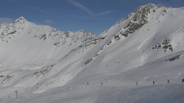 People skiing on a ski slope in the mountains 