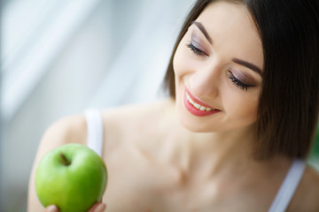 Woman With Apple. Beautiful Girl With White Smile, Healthy Teeth. High Resolution Image