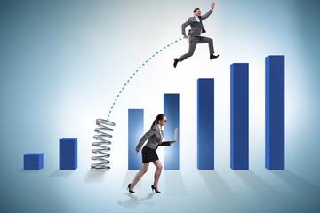 Business people jumping over bar charts
