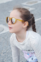 Little Girl Kid Looking Up Yellow Sunglasses Close Up Summer Portret smiling 7 Years old Girl