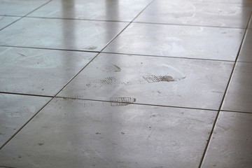 Dirty footprints on white tile