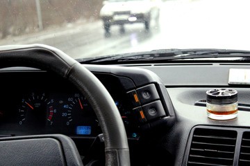 interior of the car when driving on the road in the rain
