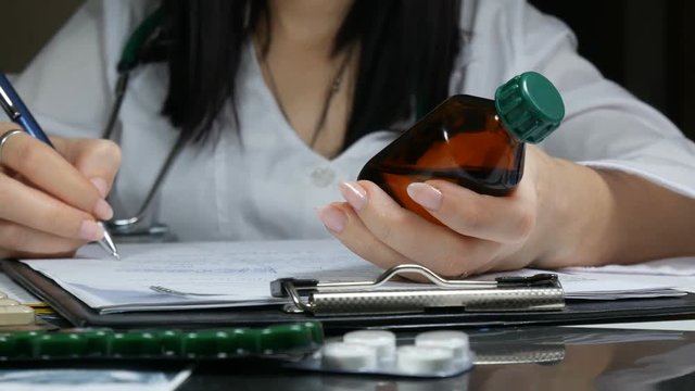 woman doctor writing prescription