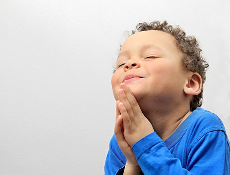 little boy praying to god stock photo