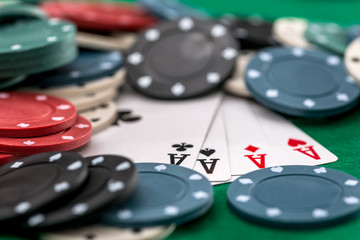 Poker chips and cards on a green background