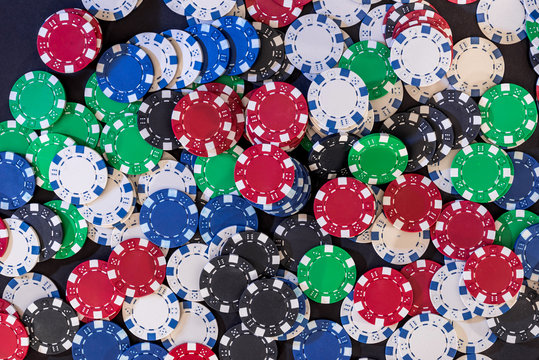 Different poker chips on table at casino