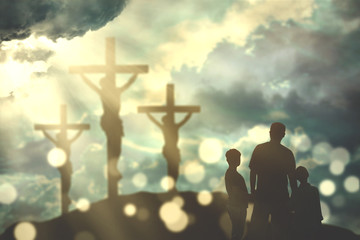 Father and children looking at three cross symbols