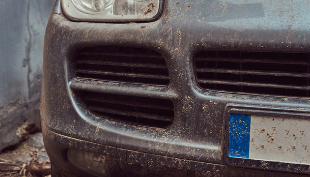 Close-up image of a dirty car after a trip around the countryside