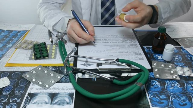 male doctor and work with medicines at the table