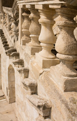 Stone staircase with balusters near old castle