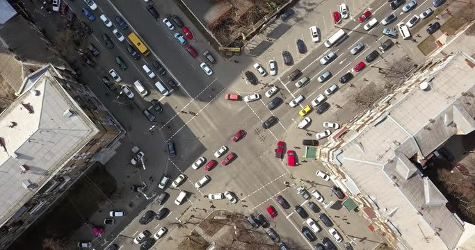 view of intersection of streets in Kiev with cars, taxis, bus and people from above in 4K