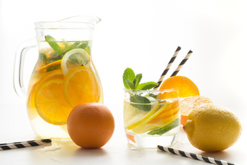 Summer detox lemonade. Water with lemon,orange, ice and mint in glass.