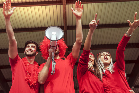 group of fans dressed in red color