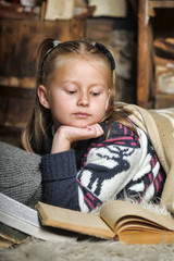 Girl schoolgirl reading book sheltering plaid
