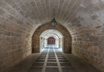 tunnel corridor with bars at the end light at the end of the tunnel